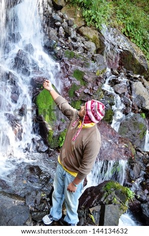Man enjoying water fall, having fun