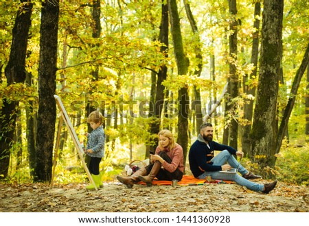 Talent development. Painting skills. Mom and dad work park while kid painting. Rest and hobby concept. Work and professional occupation. Little son painting picture in nature. Art and self expression.