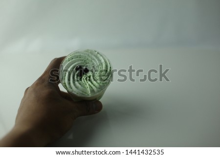 Matcha Parfait delicious creamy and sweet. green and white colour. white isolated with hand- image.