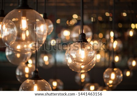 Tungsten light bulb with bokeh in background
 Royalty-Free Stock Photo #1441463156