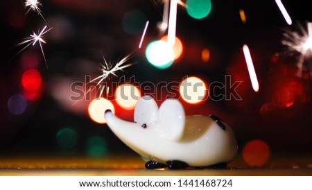New Year and Christmas 2020. Rat and fireworks, sparklers. New year images, Mouse Figurine. Christmas Rat