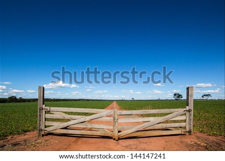 Wooden gate at farm closing the way Royalty-Free Stock Photo #144147241
