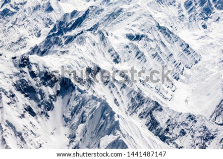 Aerial view of snowcapped mountian, peak, ridge, valley, cliff and glacier at central Karakoram or Karakorum range in Pakistan, second highest mountain range in the world.