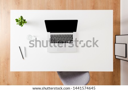 Office desktop with laptop. Top view