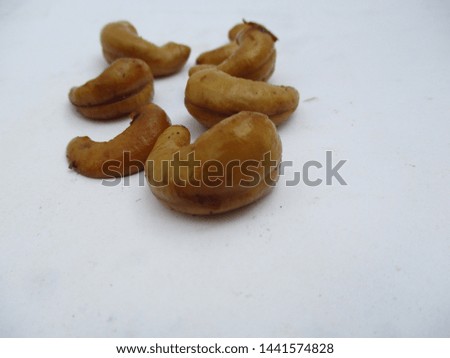 photo of cashews with background blur a stack of cashews behind it and isolated