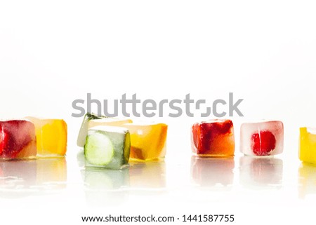 Ice cubes with fruit on a bright white background. The concept of hot summer, dessert, ice cream. Flat lay, top view