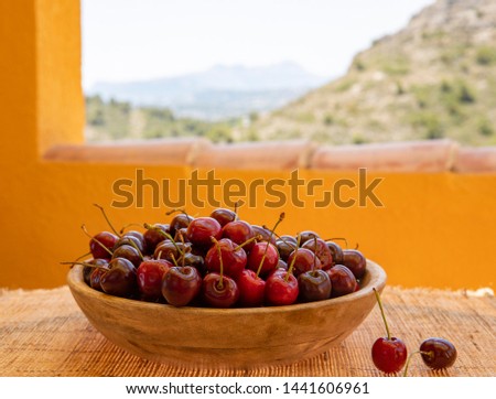 Cherries. Sweet juicy ripe sweet cherry in a wooden container close up.