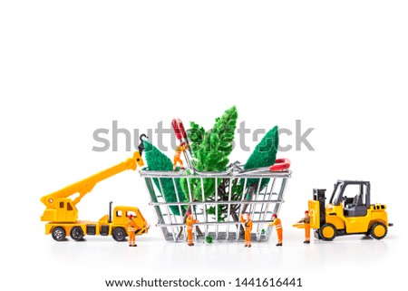 Miniature Worker Passenger Christmas Tree by Truck and forklift to shopping basket isolated on white background ,  Image for Christmas Holiday and Happy New Year Gift Celebration concept.