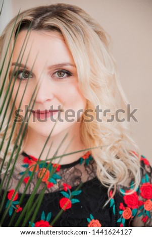 photo of close up portrait face blond woman with palm branch