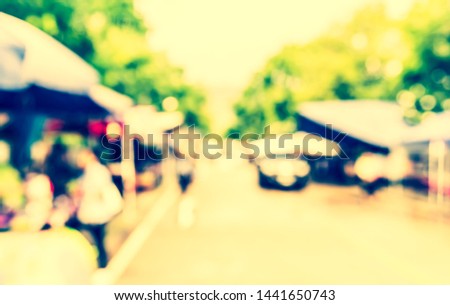 Vintage tone abstract blur image of Street day market in garden with bokeh for background usage .