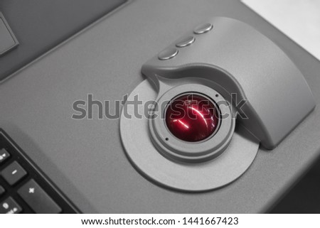 Industrial control panel made of gray steel with red trackball, close up photo with soft selective focus Royalty-Free Stock Photo #1441667423