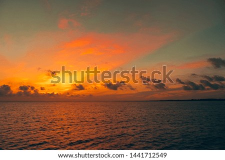 Beautiful sunrise or sunset sky on the beach. Sunset sky into the sea with wave, horizon, blue and gold sky. high-quality stock photo image of beauty landscape with sunrise over sea