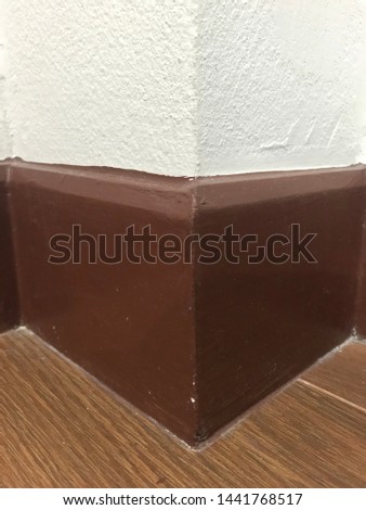Brown cornice on a white wall in new house,texture,corner