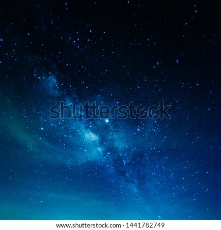 Milky Way with stars shining brightly beautiful at night on the sky background in Thailand Royalty-Free Stock Photo #1441782749