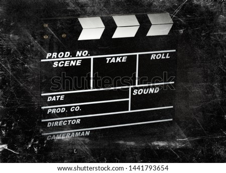 Clapperboard for the film on a dark background and scratches