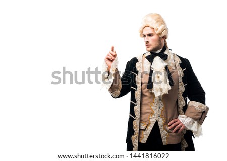 handsome victorian man standing with hand on hip and pointing with finger isolated on white  Royalty-Free Stock Photo #1441816022