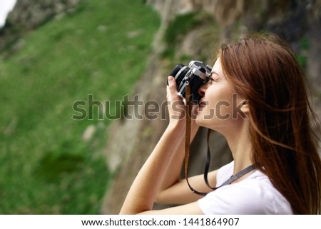 woman takes a photo of nature beauty