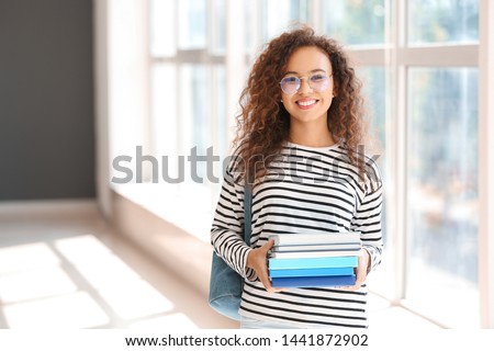 Young African-American student in university Royalty-Free Stock Photo #1441872902