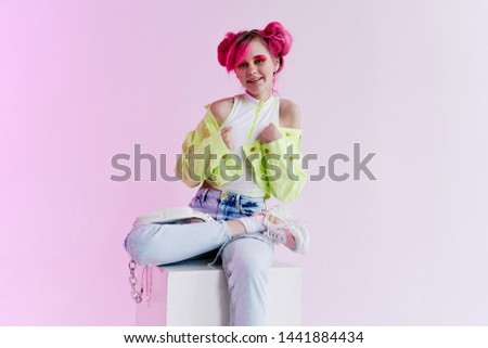 woman with pink hair is sitting on the stove