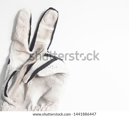 fighting golf glove with the victory sign in the with background