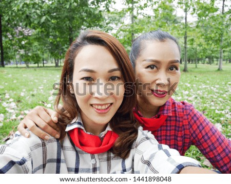 Close-up beautiful Mother and daughter are selfie photo relaxation time in the garden park.