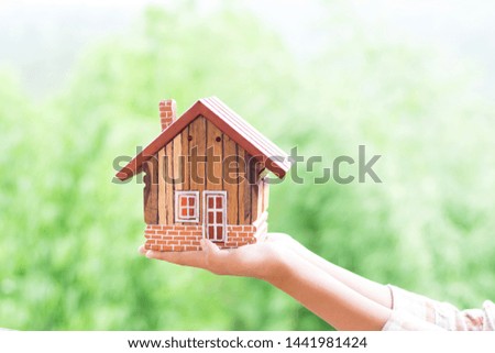 Hands holding house, Real estate investment is a business to build a house to sell to buyers in the market through agents. estate service concept