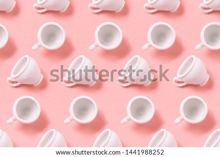 Many small white coffee cups on texture background in minimal concept