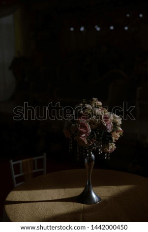 a plastic flower on the table with sunlight