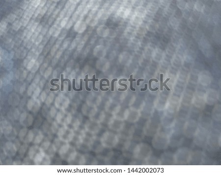 Soft blurred bokeh pattern texture of blue jeans  denim fabric background.