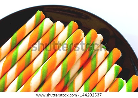 Stock Photo - colorful biscuit in balck dish  on white background