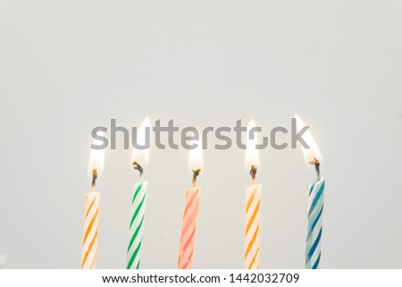 Colorful happy birthday candles close-up  with a pastel background 