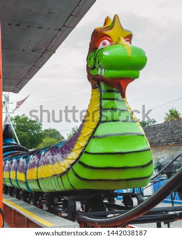 The Dragon Wagon roller coaster carnival ride located at the street fair in Erath, Louisiana for the Fourth of July Independence day festival.