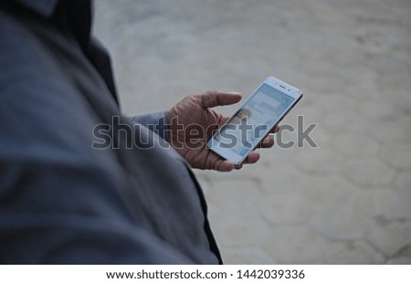 man holding phone checking for message