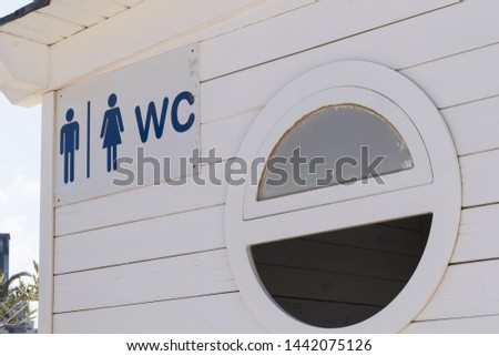 Wooden public toilet for men and women on the beach