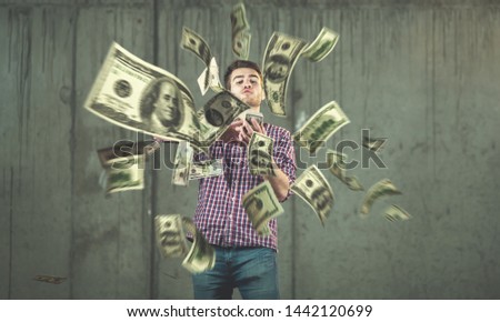 business, people and finances concept  Happy young businessman throwing US dollar banknotes and enjoying while making the rain of money in new startup office