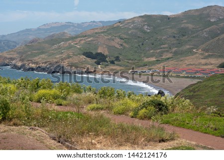 Summer Wildflowers Look Down at Rodeo Beach and Fort Chronkhite Royalty-Free Stock Photo #1442124176