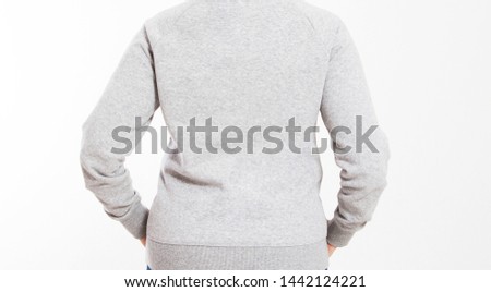 back view : beautiful european mid aged woman  dressed in a light grey casual hooded jacket - studio shot in front of a white background