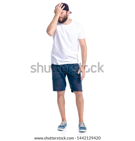 Man in shorts and cap standing thinking nervous on white background isolation