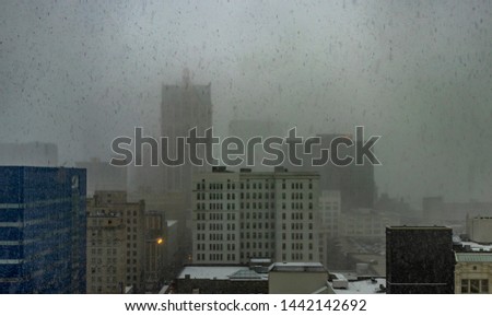 Downtown Milwaukee Skyline during a snow storm on a dreary spring afternoon, Wisconsin, USA.