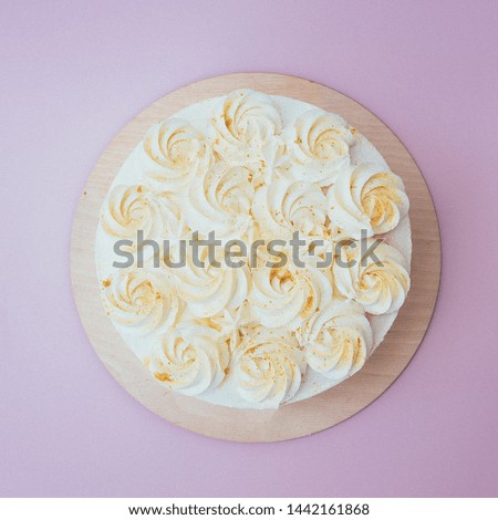 Cake plate on vintage wooden table over bokeh background.