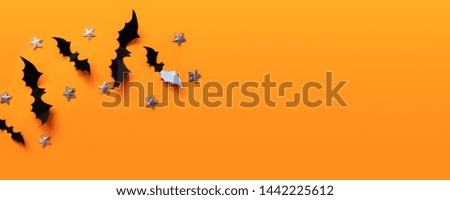Halloween banner with black but on an orange background, top view. Poster, voucher, offer, coupon, holiday sale.