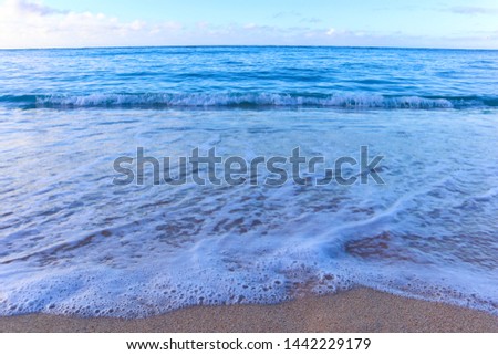 Peaceful waves rolling into shore on Waikiki beach