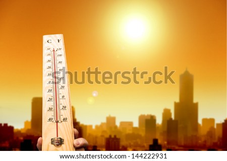 heat wave in the city and hand showing thermometer for high temperature Royalty-Free Stock Photo #144222931