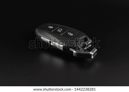 Modern car keys isolated on black background.Car key with remote alarm.