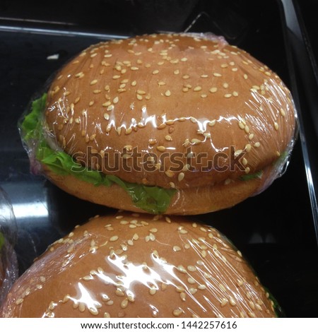 Macro photo fast food burger. Texture background juicy burger with meat and greens. Image of fast food burger pack