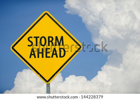 "STORM AHEAD" traffic sign with blue sky
