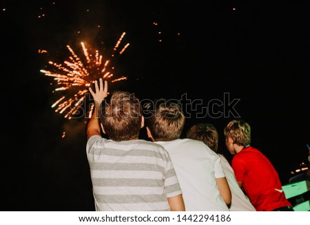 kids watching fireworks colorful four boys backs