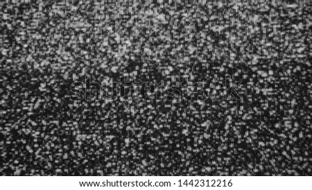 Static tv noise, bad tv signal, black and white.