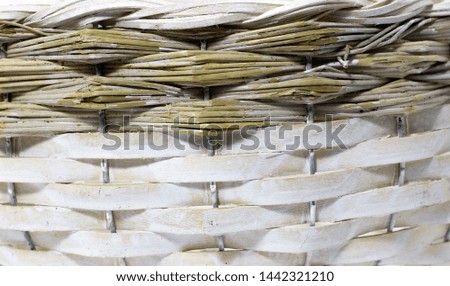 The structure and background of the wicker basket. Pattern round texture. Vertical and horizontal weave. Wicker texture in brown, white and yellow.