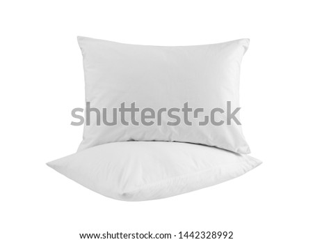 Two white pillows isolated, pillows on a white background, two pillows piled against white background. Side view.